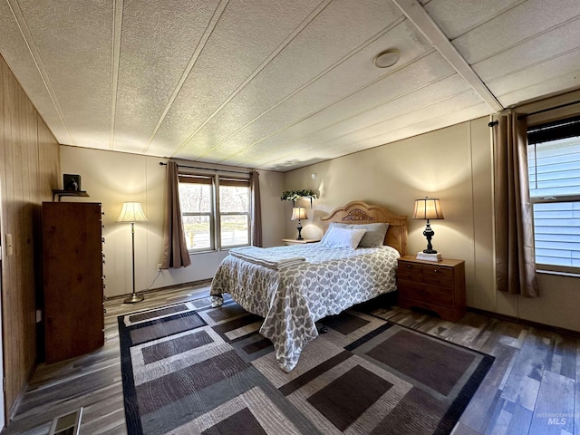 bedroom featuring a textured ceiling and dark wood-type flooring