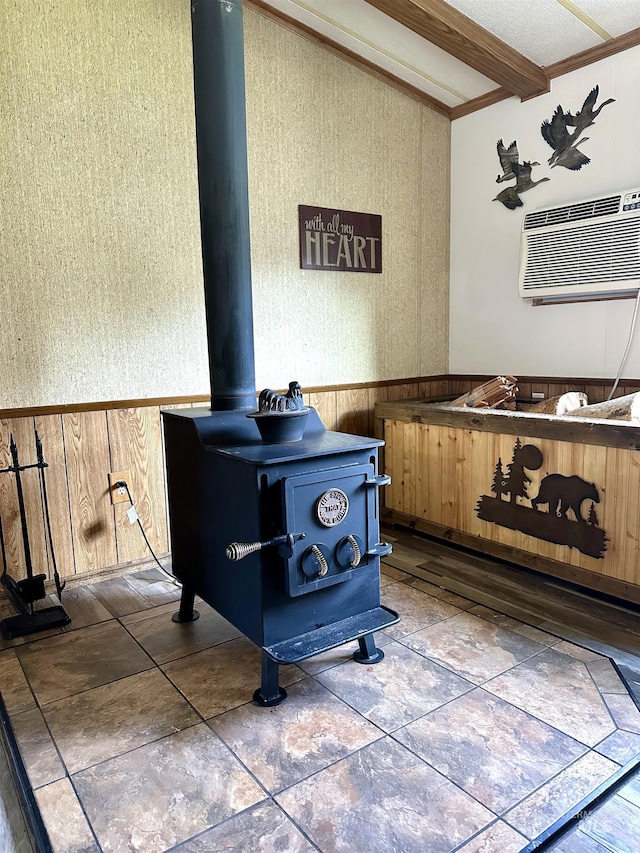 room details featuring a wood stove, a wall mounted AC, and wood walls