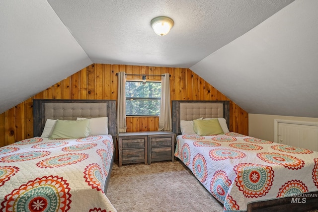 bedroom featuring wood walls, lofted ceiling, carpet floors, and a textured ceiling