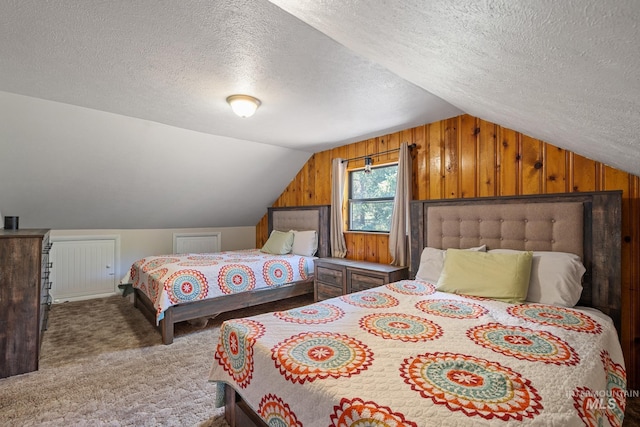 carpeted bedroom featuring vaulted ceiling, a textured ceiling, and wooden walls