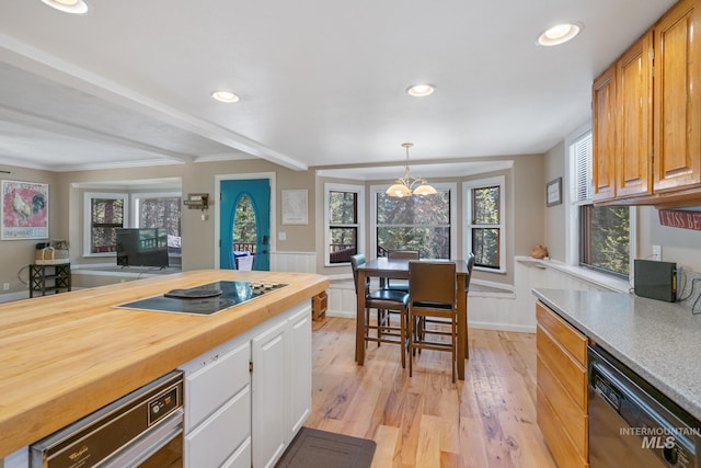 kitchen with dishwasher, butcher block countertops, black electric cooktop, light wood finished floors, and white cabinets