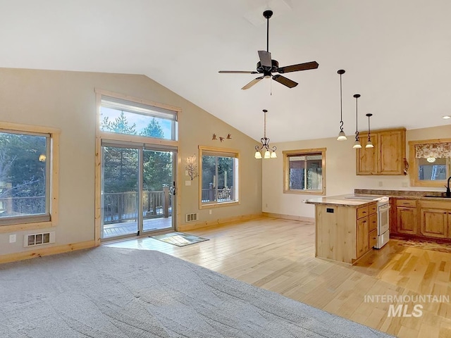 kitchen featuring light countertops, white electric range, light wood finished floors, and visible vents