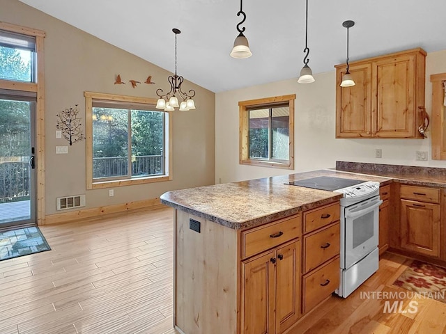kitchen with white range with electric cooktop, light wood-style flooring, a peninsula, a wealth of natural light, and vaulted ceiling