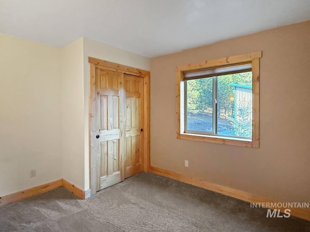 unfurnished bedroom featuring baseboards and carpet floors
