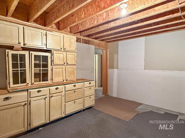 basement featuring dark carpet