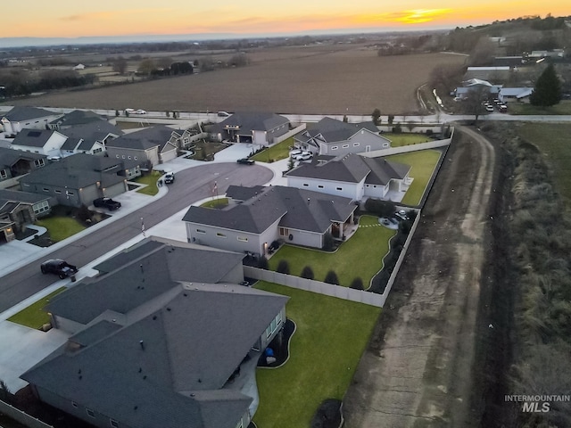 aerial view at dusk featuring a residential view