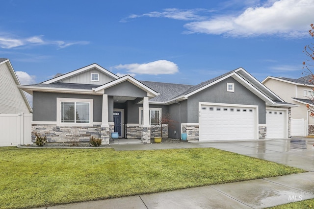 craftsman house featuring a garage and a front yard