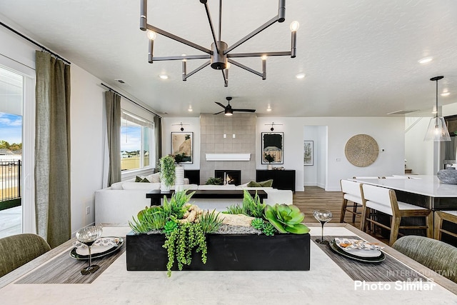 5543 E Bridal Veil Falls Dr, Nampa, ID 83686 - living room with wood finished floors, a fireplace, baseboards, a chandelier, and ceiling fan