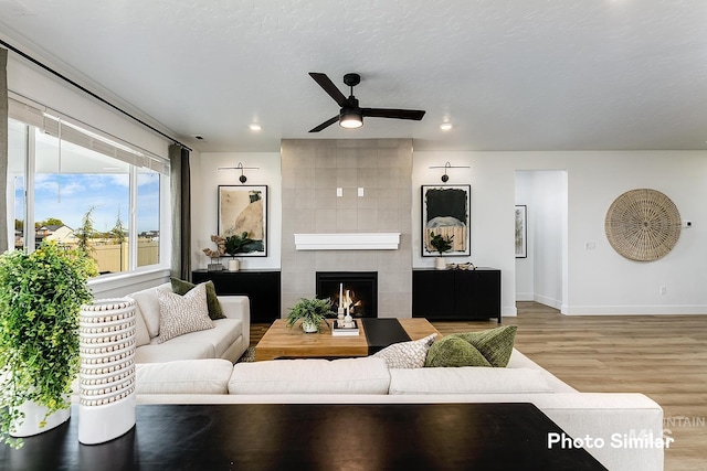 5543 E Bridal Veil Falls Dr, Nampa, ID 83686 - living area featuring ceiling fan, light wood finished floors, baseboards, a tiled fireplace, and recessed lighting