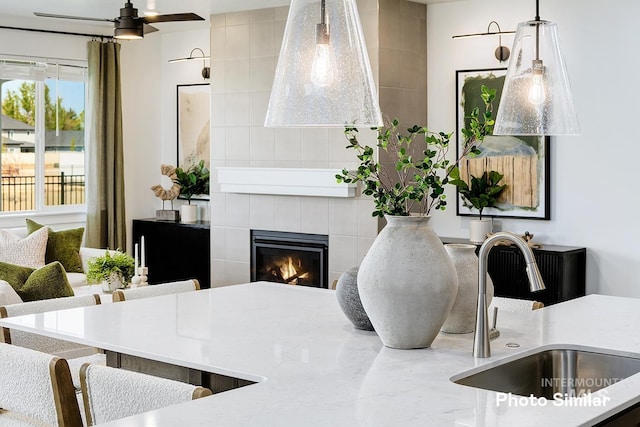 5543 E Bridal Veil Falls Dr, Nampa, ID 83686 - dining area view of a sink, a ceiling fan, and a fireplace