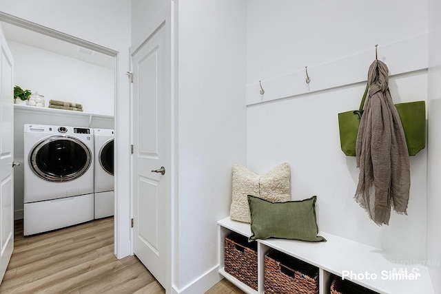 5543 E Bridal Veil Falls Dr, Nampa, ID 83686 - washroom featuring washing machine and dryer, light wood-style flooring, and baseboards