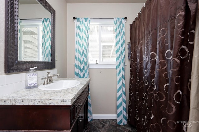 bathroom with vanity and baseboards