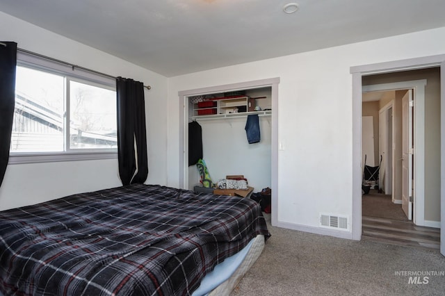 bedroom featuring carpet, a closet, visible vents, and baseboards