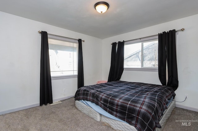 carpeted bedroom with baseboards