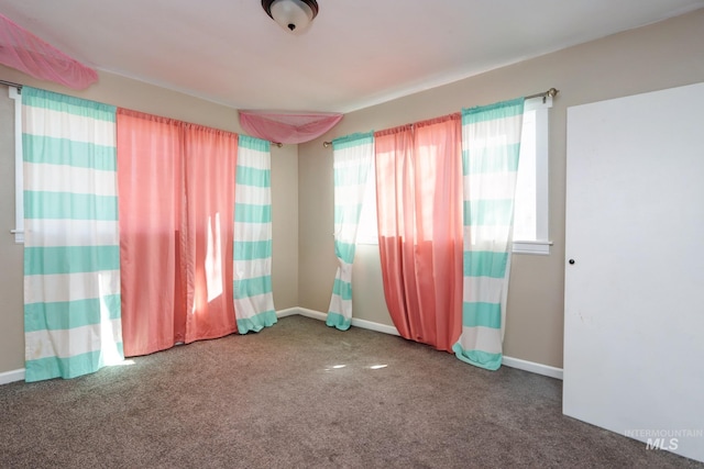 carpeted empty room with baseboards