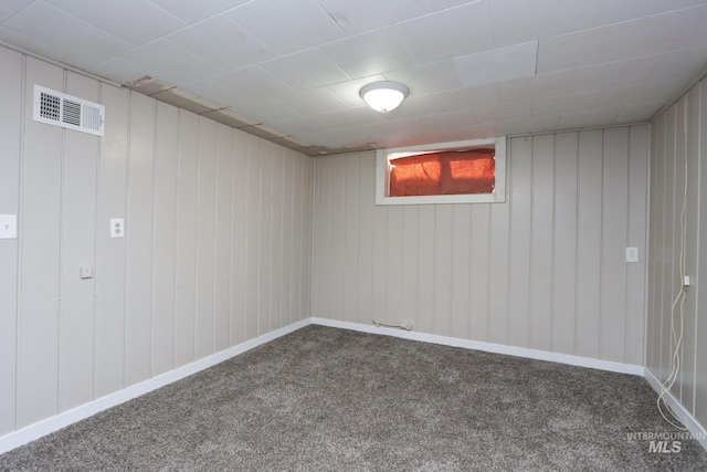 basement with carpet flooring, visible vents, and baseboards