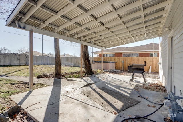 view of patio featuring a fenced backyard and a hot tub