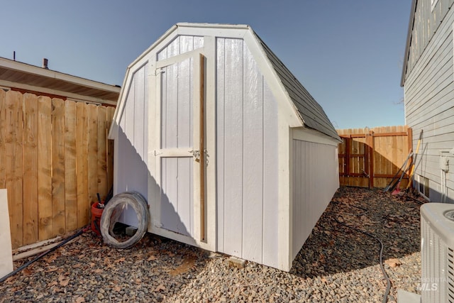 view of shed featuring a fenced backyard and central air condition unit