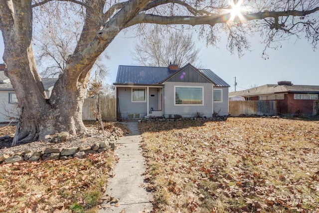 view of front of house featuring fence and a chimney