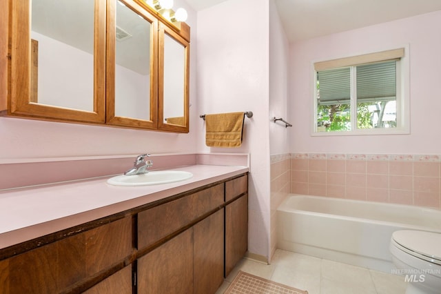 bathroom with tile patterned flooring, vanity, toilet, and a bathtub