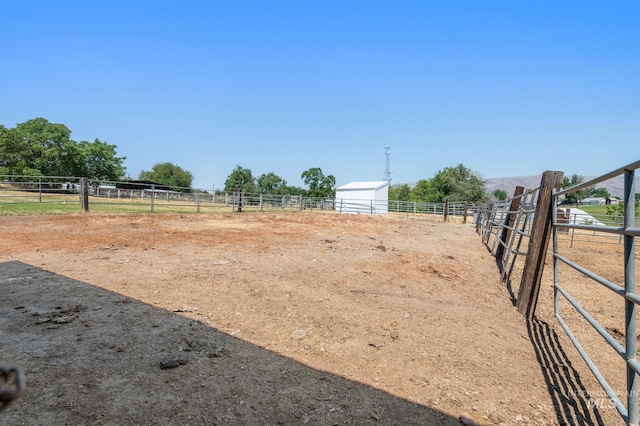 view of yard featuring an outbuilding and a rural view