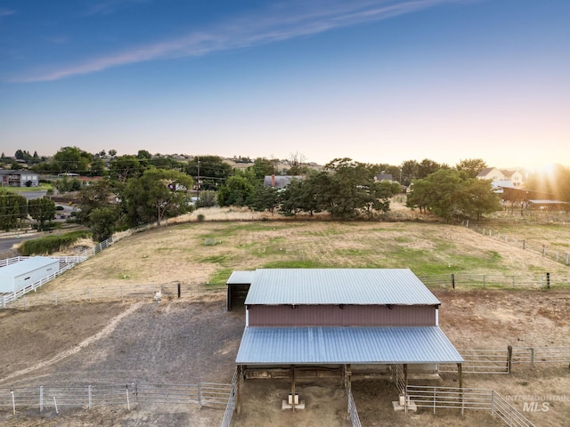 exterior space with a rural view and an outbuilding