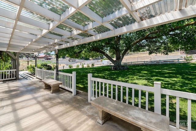 deck featuring a yard, a pergola, and a patio