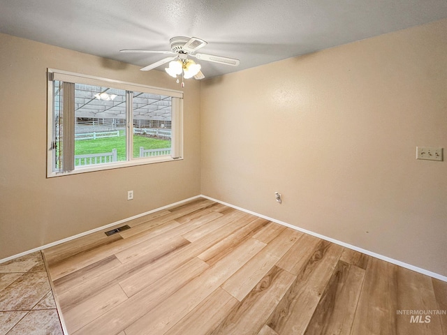 spare room with wood-type flooring and ceiling fan