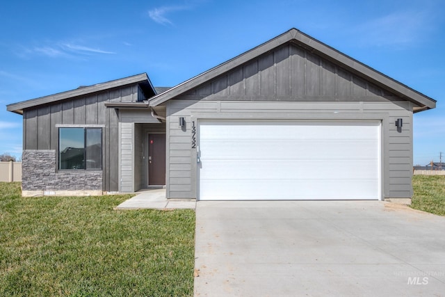 view of front of property featuring board and batten siding, driveway, a front yard, and a garage
