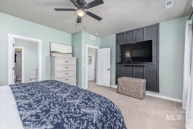 carpeted bedroom featuring baseboards, a textured ceiling, a ceiling fan, and connected bathroom