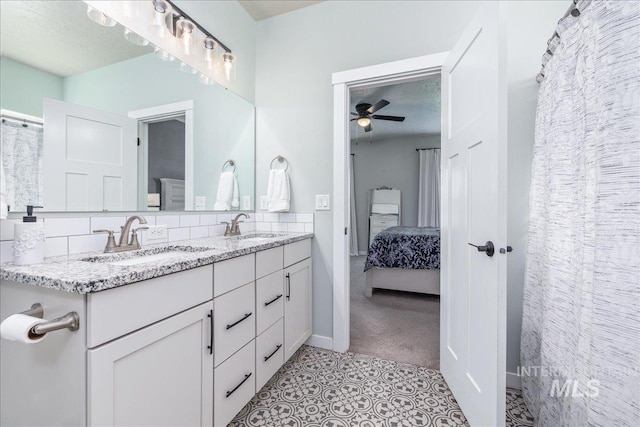 bathroom featuring a ceiling fan, double vanity, ensuite bath, backsplash, and tile patterned flooring