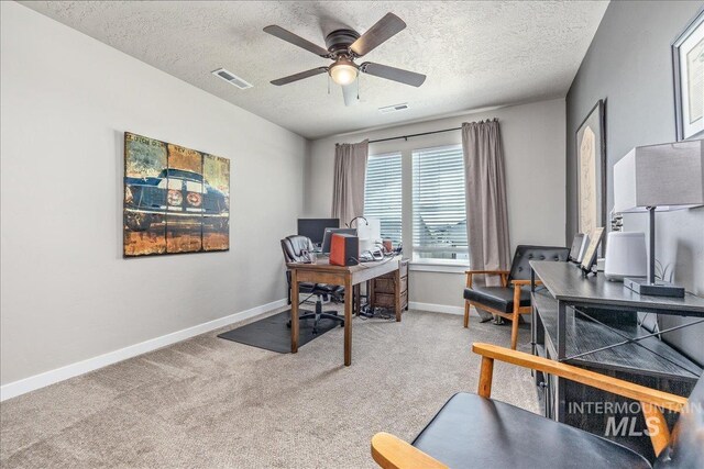 office area featuring carpet, ceiling fan, baseboards, and a textured ceiling