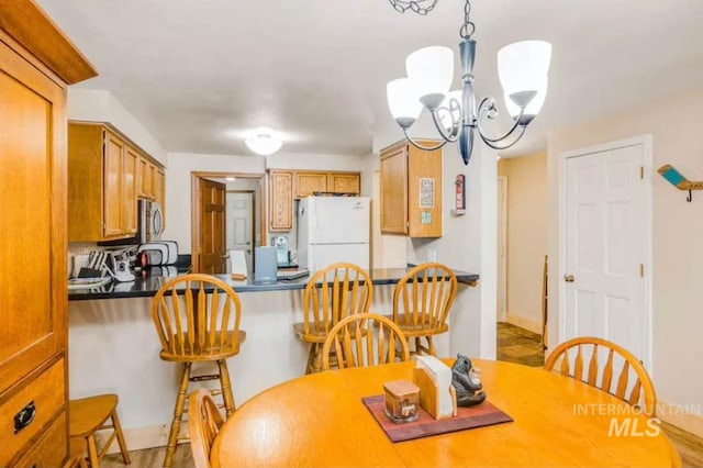 dining space with an inviting chandelier