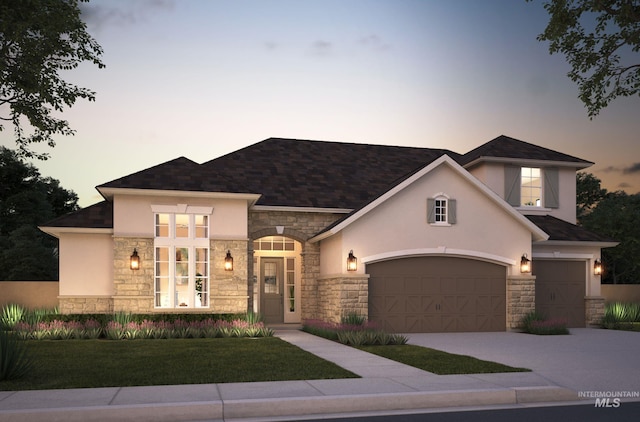 view of front of property featuring a garage, stone siding, driveway, and stucco siding