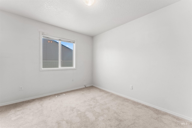 816 W Georgia Ave, Nampa, ID 83686 - spare room with light colored carpet, baseboards, and a textured ceiling