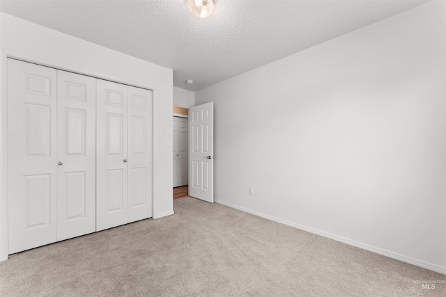 816 W Georgia Ave, Nampa, ID 83686 - unfurnished bedroom featuring carpet floors, a closet, baseboards, and a textured ceiling