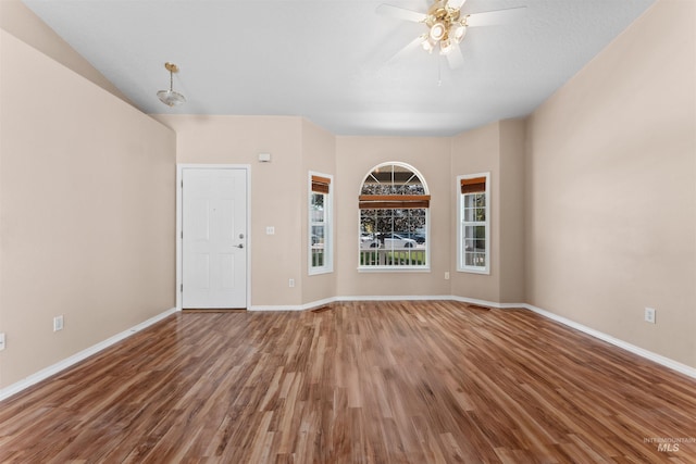 816 W Georgia Ave, Nampa, ID 83686 - unfurnished living room featuring wood finished floors, baseboards, and a ceiling fan