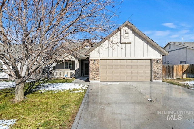 view of front of home with a garage, covered porch, and a front yard