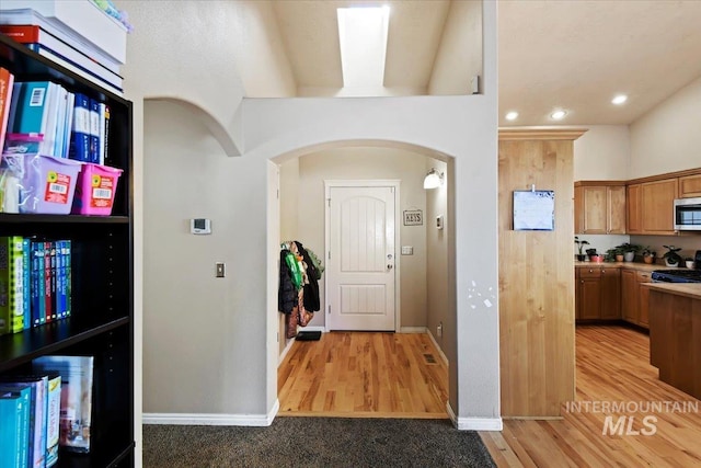 interior space with range and light hardwood / wood-style floors