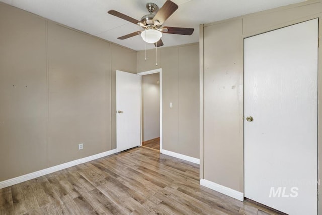 unfurnished bedroom featuring baseboards, ceiling fan, and wood finished floors