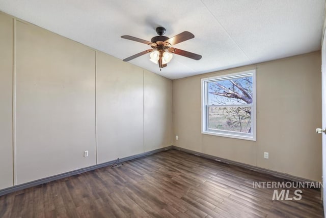 unfurnished room featuring baseboards, a ceiling fan, a textured ceiling, and wood finished floors