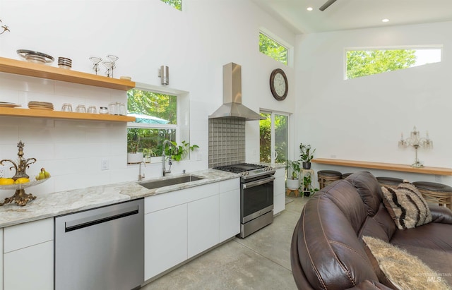 712 E Sheridan, Nampa, ID 83686 - kitchen with stainless steel appliances, island range hood, concrete floors, tasteful backsplash, and white cabinets