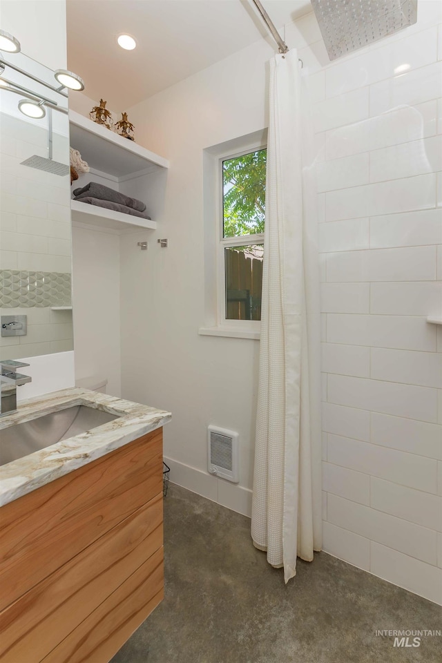 712 E Sheridan, Nampa, ID 83686 - bathroom with vanity, concrete floors, tiled shower, and heating unit