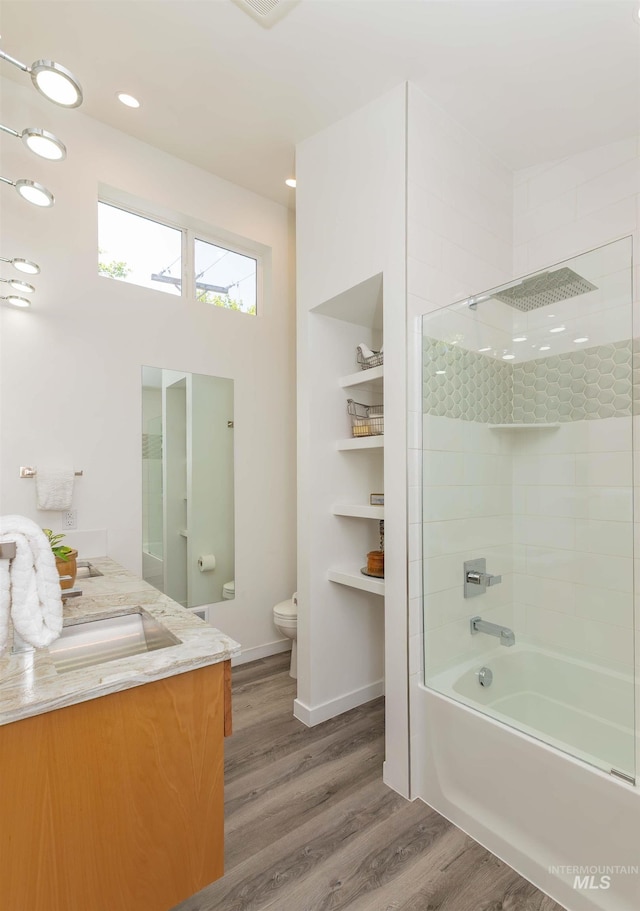 712 E Sheridan, Nampa, ID 83686 - bathroom featuring wood finished floors, vanity, shower / bathtub combination, and recessed lighting