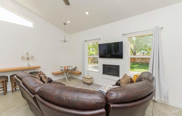 712 E Sheridan, Nampa, ID 83686 - living area featuring a glass covered fireplace, concrete floors, vaulted ceiling, and recessed lighting
