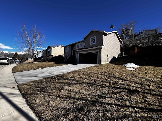 view of side of property with a garage and driveway