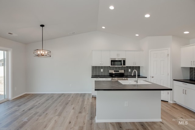 kitchen featuring decorative light fixtures, light wood-type flooring, stainless steel appliances, and plenty of natural light