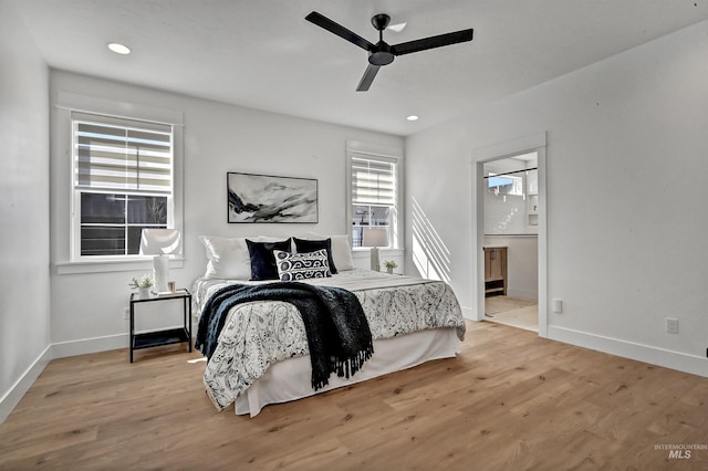 bedroom with recessed lighting, baseboards, ensuite bath, and wood finished floors