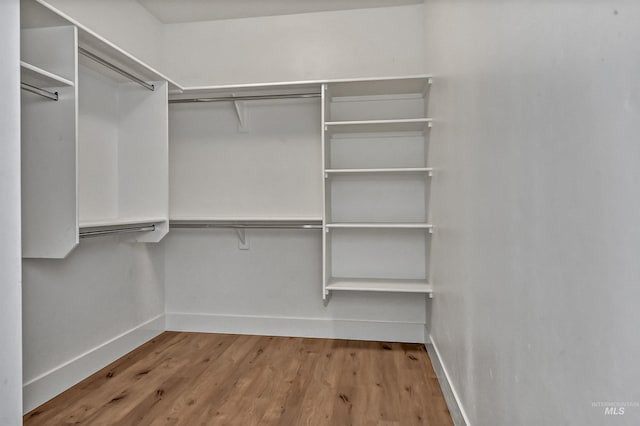 spacious closet with wood finished floors