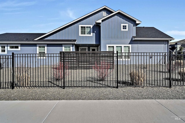 view of front of home featuring board and batten siding and fence private yard